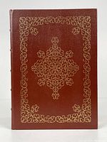 Front cover of the leather-bound book with ornate gold embossing.