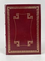 Front cover of the burgundy leather bound book with gold gilt decoration.