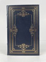 Front cover of the book showing full dark leather with gold embossed ornamental design.