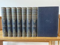 Front view of all 8 Waverley Pictorial Dictionary volumes showing spine titles and decorative gold designs.