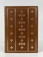 Front cover of the full leather bound book showing gold embossed decorative patterns