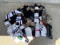 Overview of the sock lot including various brands like NEXT, McGregor, Superstar; multiple colors and styles visible; some packs opened