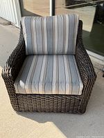 Front view of wicker patio chair with cushions