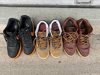 Top down view of three pairs of Nike shoes side by side showing overall condition and color combinations.