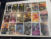 Photo of 18 limited run comic books with various super hero characters and series