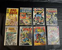 Lot of 8 vintage comic books laid out on a flat surface showing front covers including Sad Sack, Captain Hero, GI Combat, Avengers, Korak Tarzan, and Thor