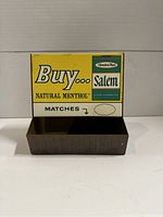 Front view showing the Salem Natural Menthol Matches advertising on a yellow and white background with a dark brown base.