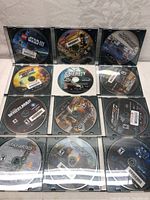 Photo showing all 12 PlayStation 3 game discs in cases, games include LEGO Star Wars III, Wheelman, Dirt 2, Call of Duty, Uncharted, and others.
