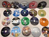 Top view of all 20 Wii game discs laid out on a white surface, showing disc artwork and titles.
