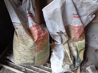 Two large bags of SP polymeric sand showing branding and condition, one bag opened, one unopened.