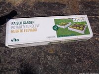 Long view of sealed cardboard box labeled 'Raised Garden' by Vita