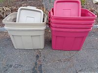 6 Rubbermaid Roughneck storage totes stacked in two groups: 3 brown on left with lids on top, 3 pink on right with lids stacking inside.