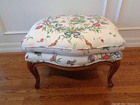 Full view of stool front showcasing floral cushion and wooden base