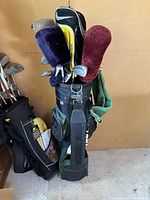 Golf bag filled with clubs, including multiple headcovers visible.
