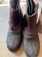 Top view of pair of hunting boots showing rubber toe and brown leather uppers.