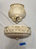 Two-piece fountain style planter with grapevine and leaf decorative motifs. Top piece with spout and lower rounded planter bowl.