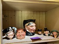 Shelf displaying six pirate themed Toby mugs, various sizes and designs.