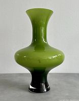 Front view of the MCM lime green art glass vase, showing the shape and color gradient from lime green to black base.