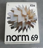 Closed original box with image of Norm 69 pendant lamp and branding on top.