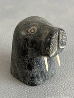 Front right three-quarter view showing tusks and carved eyes.