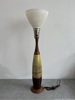 Full view of the vintage table lamp showing the ceramic base and glass shade unlit.