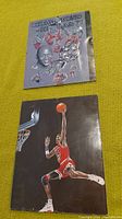 Two Chicago Bulls pictures placed on yellow background, one commemorative 'Champions At Last' image and one action shot of Michael Jordan dunking.