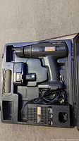 Mastercraft cordless drill, battery, and charger in molded plastic case interior.