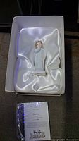 White porcelain Royal Doulton Darling figure with brown hair in white satin-lined box, certificate card included.
