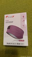 Front of the product box showing the iLexT 2in1 Sleep Headphones Sports Headband FULH01 with features listed including microphone, music and calling support.