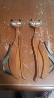 Pair of wooden Siamese cat decorations showing the full length, front view.