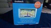 Front of Garmin nüvi 750 retail box showing device with map on screen and personal travel assistant features listed