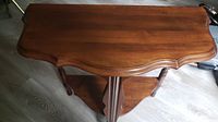 Top view showing curved and scalloped edge of the half moon wooden table.