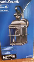 Photo of Heath/Zenith motion activated outdoor lantern light in original box showing the product and packaging details.