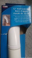Photo of front of blue retail packaging showing '12" Wall Grab Bar' and image of grab bar held by hand.