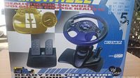 Photo of the racing wheel, pedals and shifter in original packaging showing product image and branding.