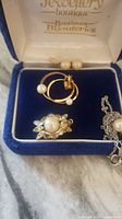 Set of vintage 14k gold hoops with pearls, pearl and rhinestone brooch, and pearl pendant necklace in blue velvet jewelry box.