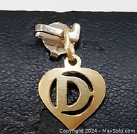 Front view of the yellow gold heart pendant with letter D cut-out.