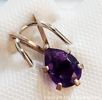 Close-up front view of the sterling silver pendant showcasing the teardrop amethyst and crisscross bail design.