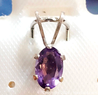 Front view of oval purple amethyst pendant with six prong setting in sterling silver.