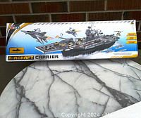 Photo of the aircraft carrier play set box front showing the assembled carrier, jets, and helicopter in flight.