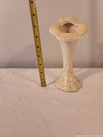 Front view of the Belleek Irish vase with measuring tape showing height approximately 8 inches.