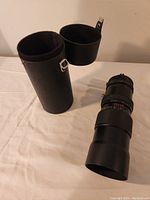 Photo of the lens next to the protective carrying case showing overall condition and size