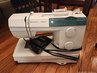 Front-angle view of the sewing machine with foot pedal attached