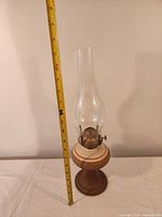 Full view of the oil lamp with a measuring tape indicating height of approximately 14 inches.