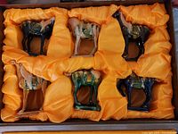 Top view of all 6 horses in orange silk-lined packaging showing colors and arrangement