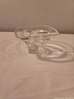 Full view of the crystal dish showing the overall shape and transparency.