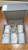 Open box view showing all six tumblers with packing tissue