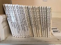 All 22 volumes of Beatrix Potter's The Tale of Peter Rabbit collection with titles visible on spines, arranged in order.