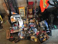 Overview of large lot showing wide array of car and trailer parts including GMC grill, wiring, lights, and other components.