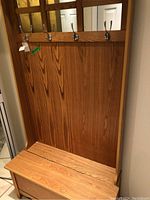 Back panel and bench of wooden coat bench with hooks, showing overall height, wood finish, and condition.